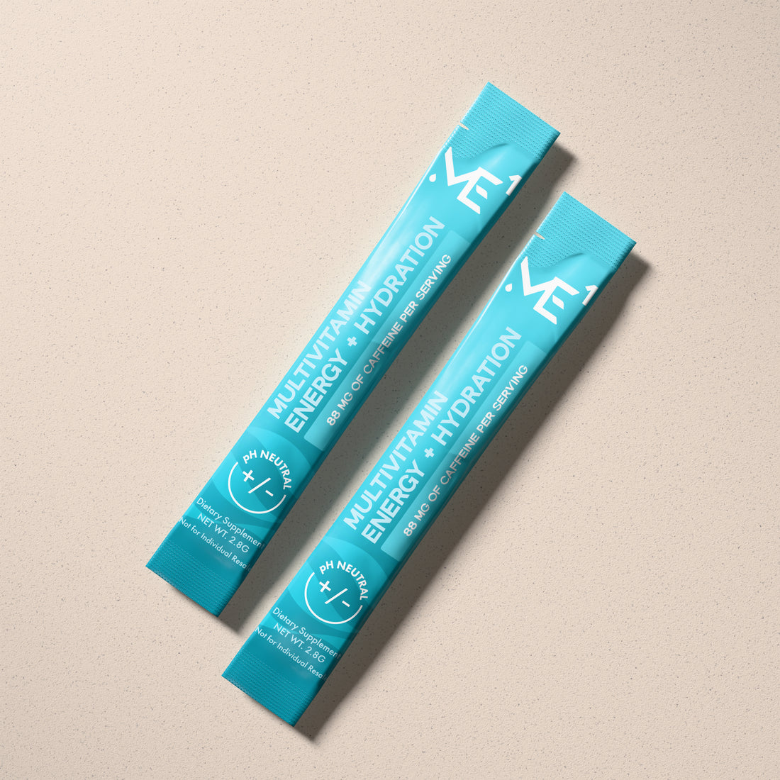 Two blue packets of multivitamin energy and hydration on a beige background
