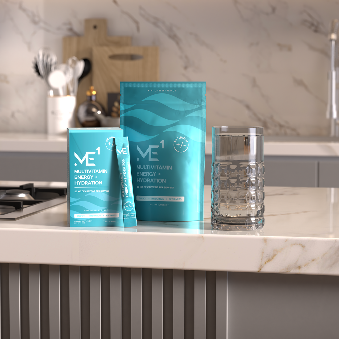 Two blue ME1 multivitamin energy hydration packets on a kitchen counter with a glass.