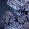 Close-up of metallic ore with a dark blue gradient background